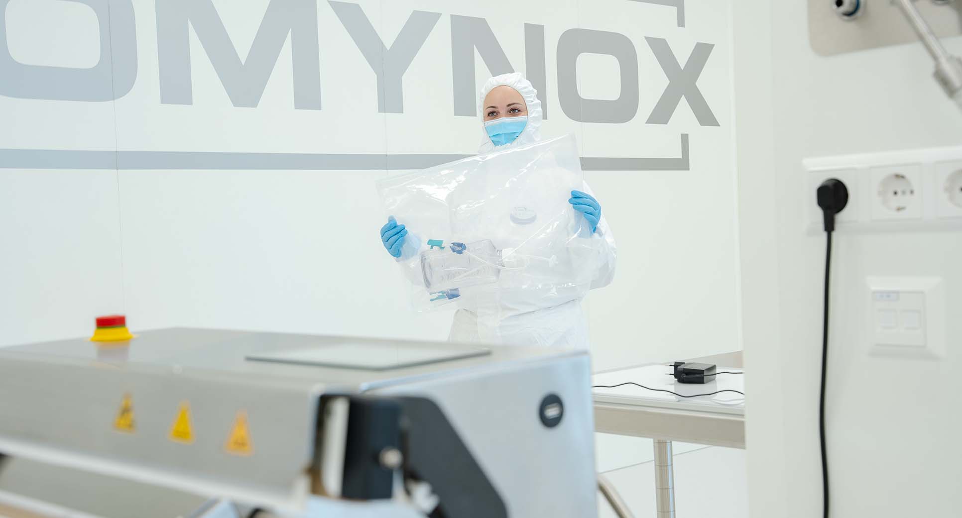 Romynox employee working on equipment in the cleanroom.